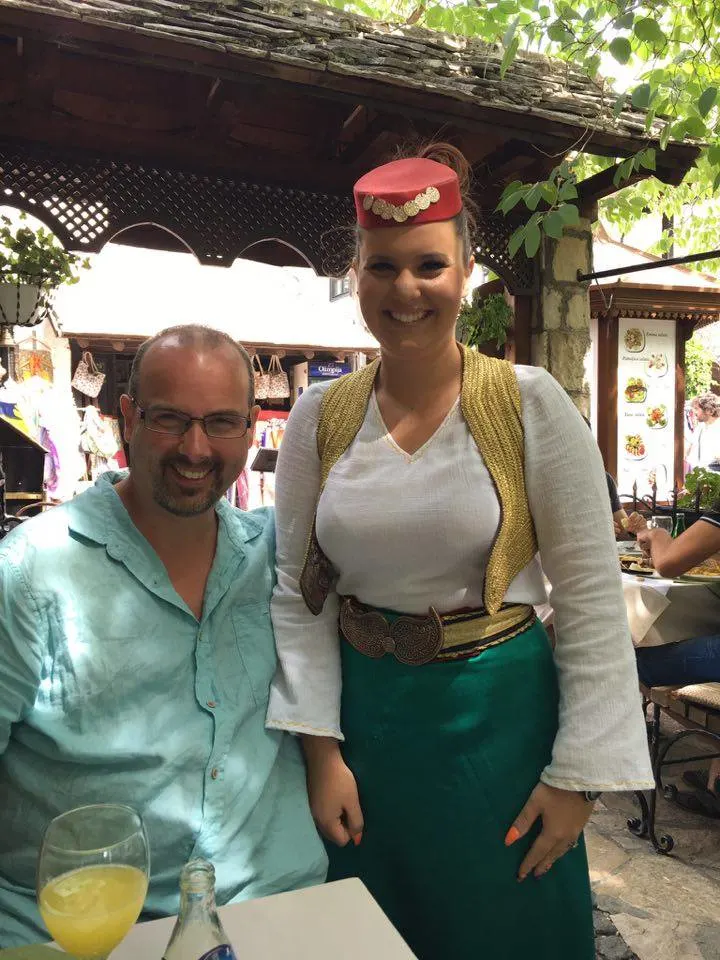 a waitress in national dress at a restaurant in bosnia herzegovina