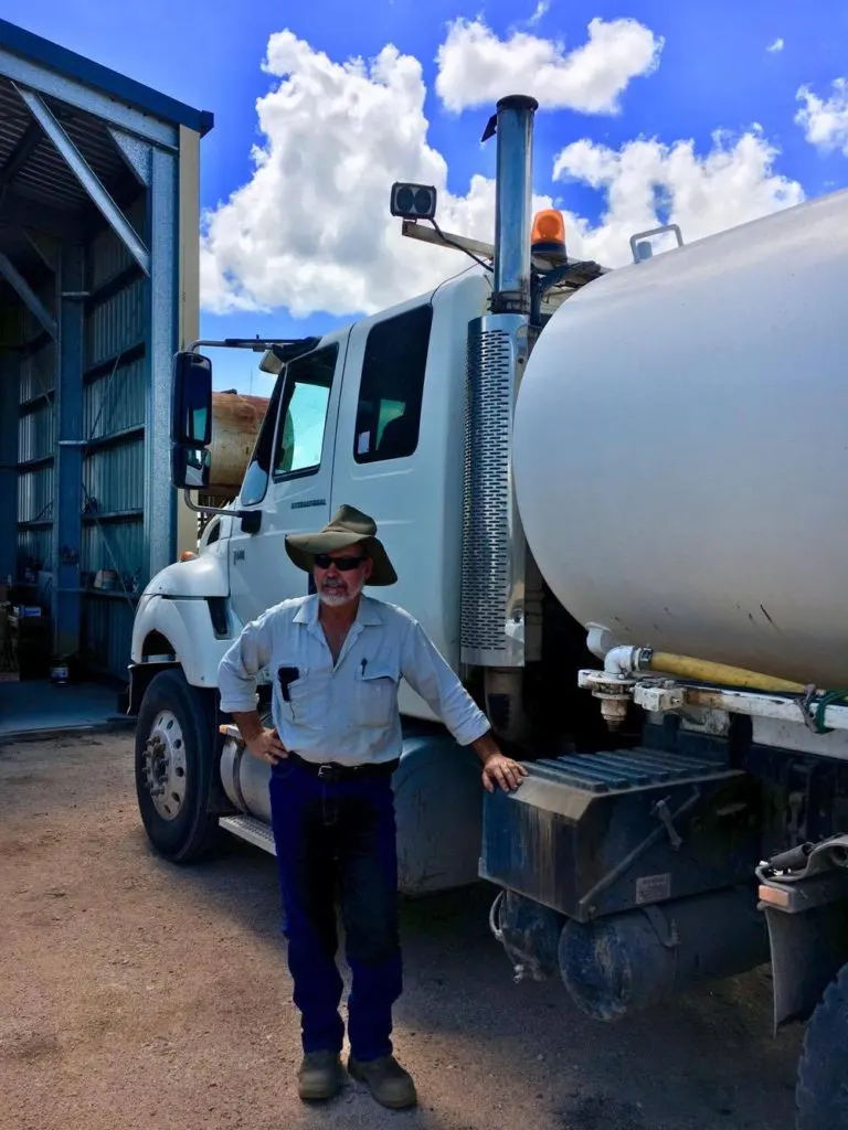 visiting a sugar cane farm - Peter standing by the dunder truck
