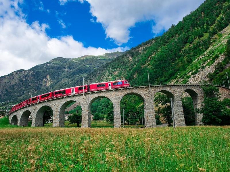 The Bernina Express in Switzerland loops around on a bridge