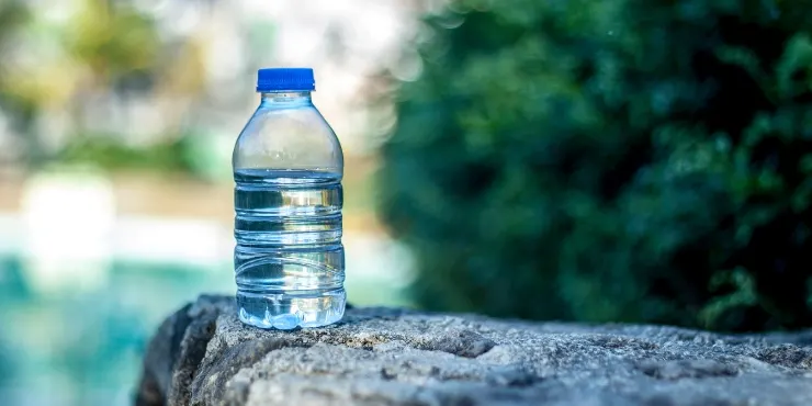 A water bottle on a rock.