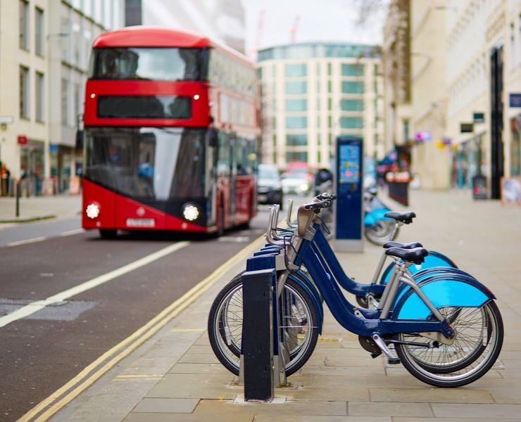 Santander bicycles with a red bus in the background.