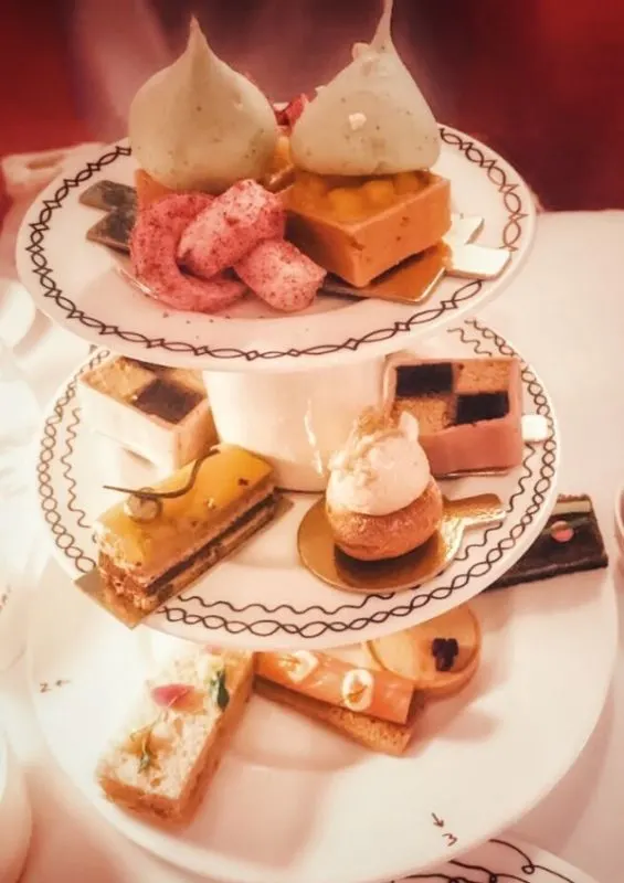 Sketch afternoon tea with cakes and savouries on a three tier plater