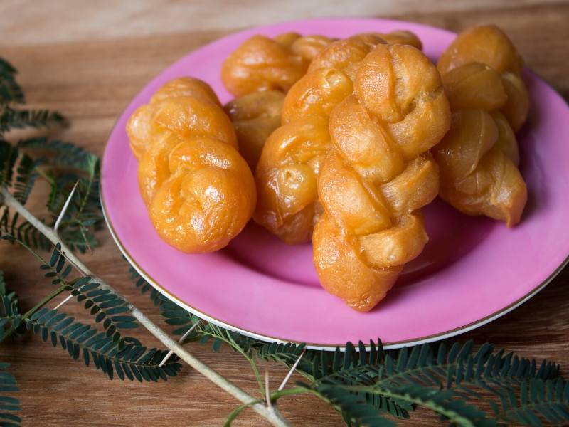 A pile of pastries on a pink plate