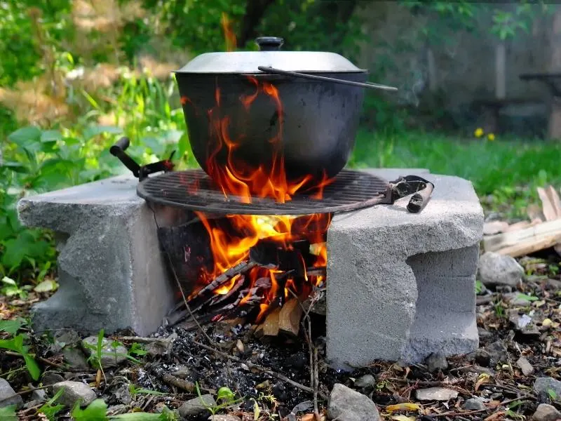 A black cooking pot on a fire