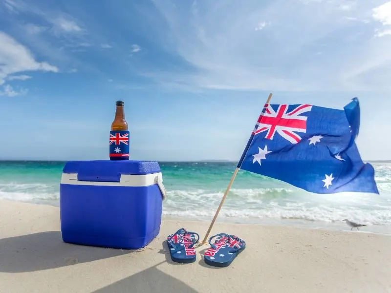 Australian flag with a pair of thongs on a beach!