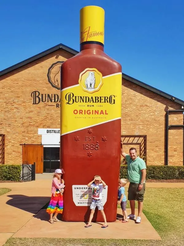 Big bottle with a family standing under it