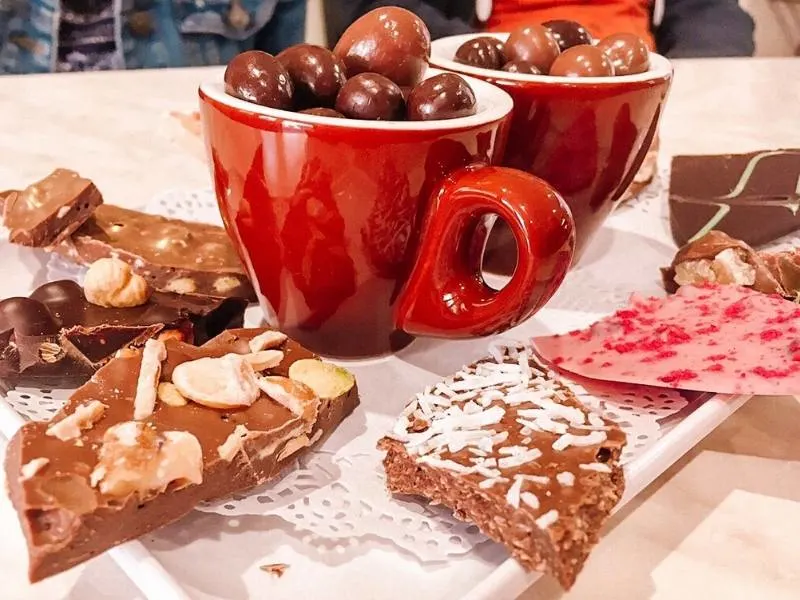 Some chocolates and a cup of hot chocolate on a plate