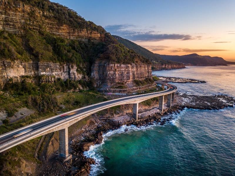 A road bridge along the coast and sea below