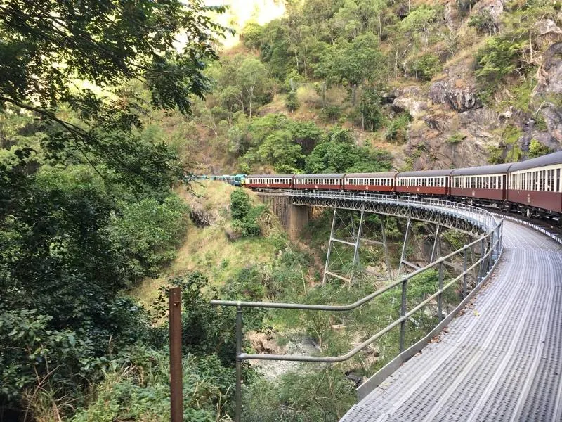 A train curves round a bend in Australia called the Kuranda railway one of the top things to do in Queensland