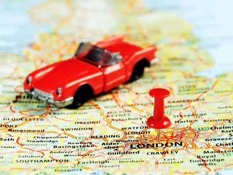 A map of London and a model red car all things about visiting england for the first time.