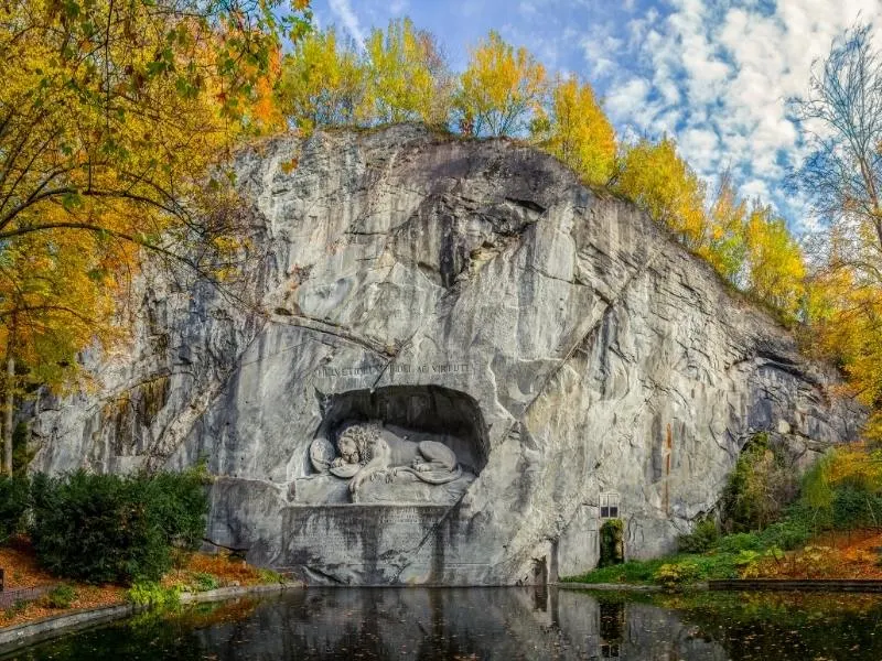 A lion carved out of the side of rock