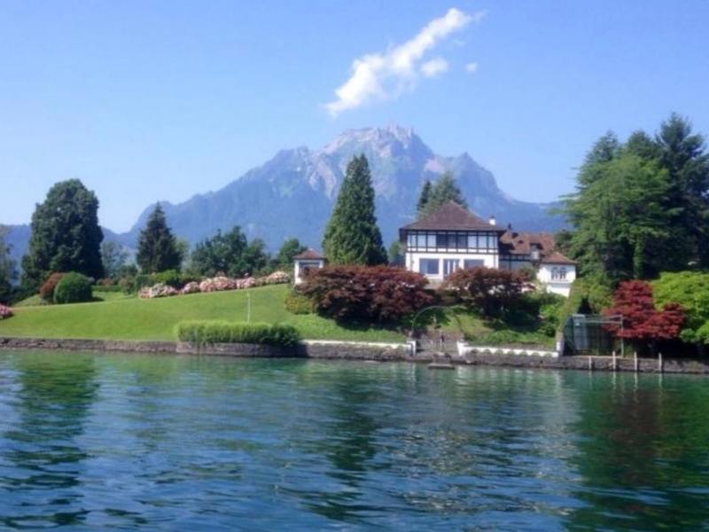 A house on the edge of Lake Lucerne with Mt Pilatus in the background