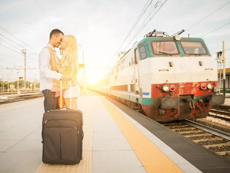 Couple beside a train