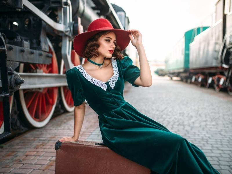 Girl posing by a train
