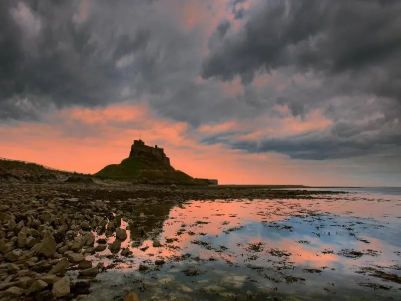 Sunset over Lindisfarne Castle one of the most memorable things to do on Holy Island