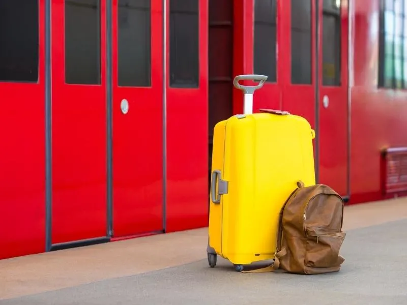Luggage beside a train