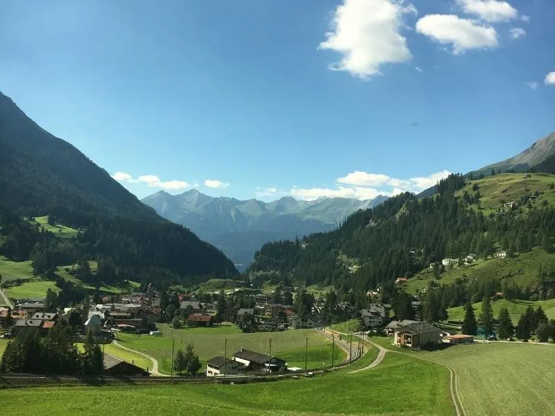 Views of Swiss chalets, meadows and mountains