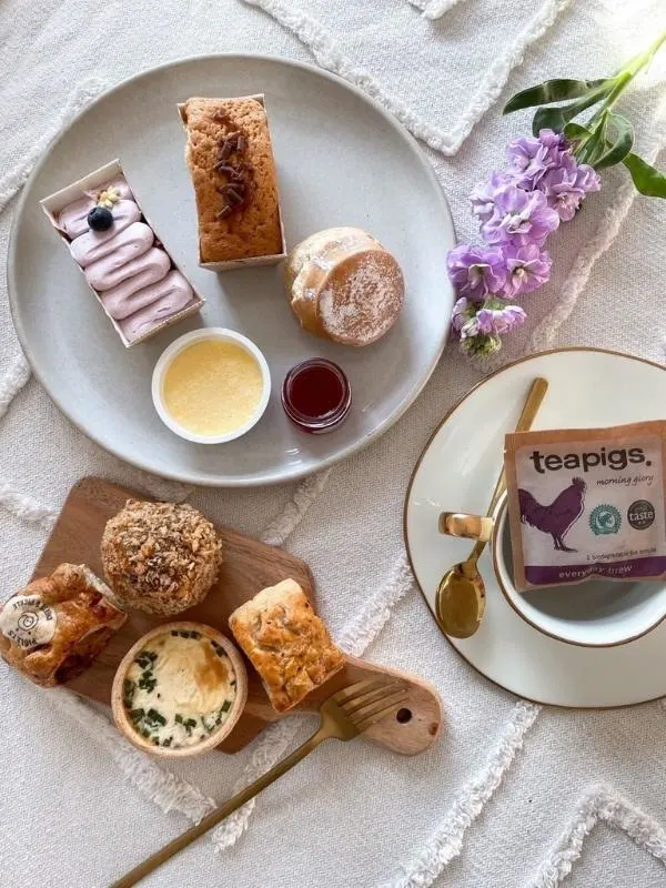 Piglet's Pantry afternoon tea with tea bags, scones and cakes from their afternoon tea in a box range.