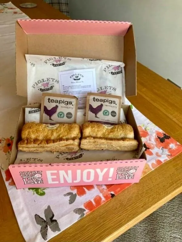Piglet's Pantry afternoon tea in a box showing sausage rolls and teapigs