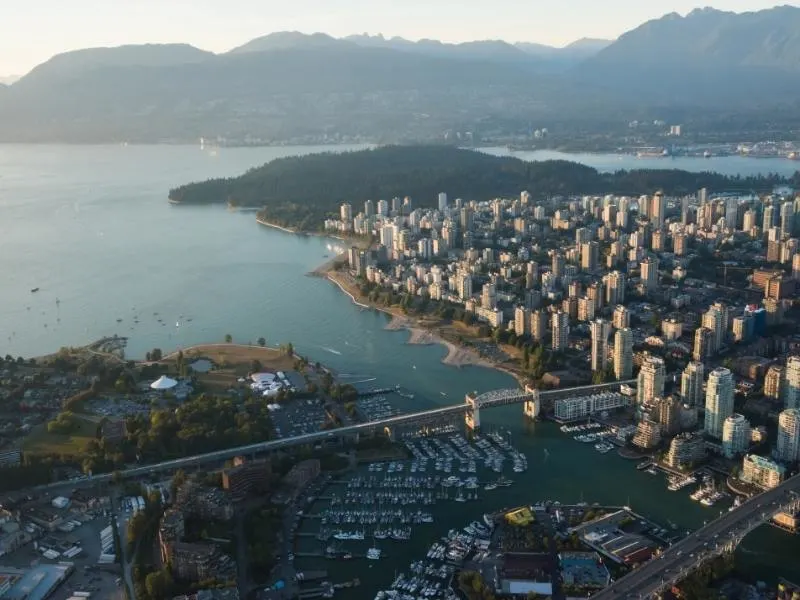 Aerial view of Vancouver with mountains in the background.