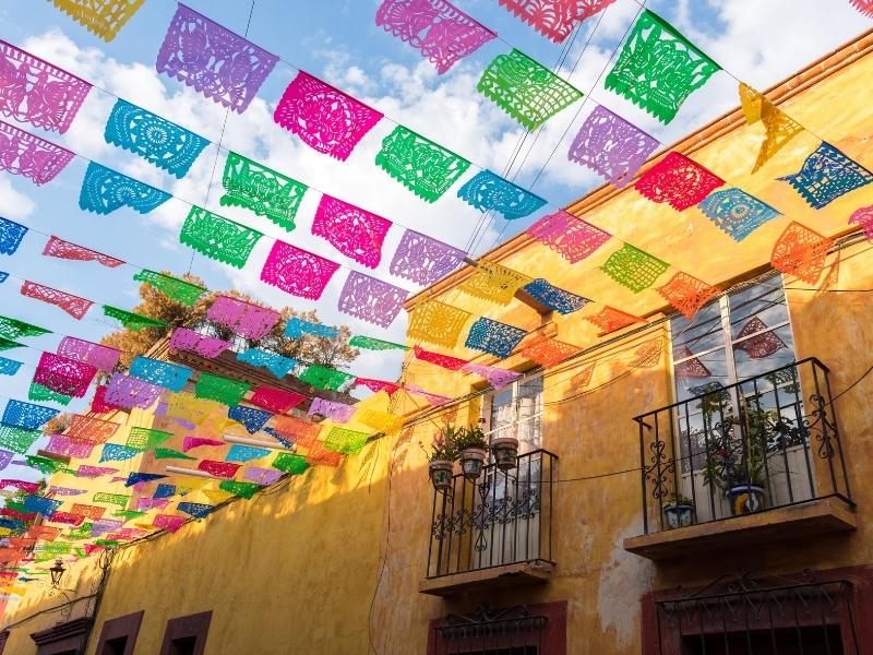 Colourful flags above a Mexican street.