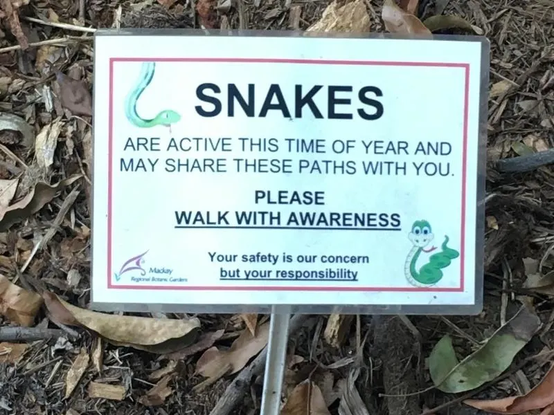 Sign telling to beware of snakes at the botanical gardens in mackay.