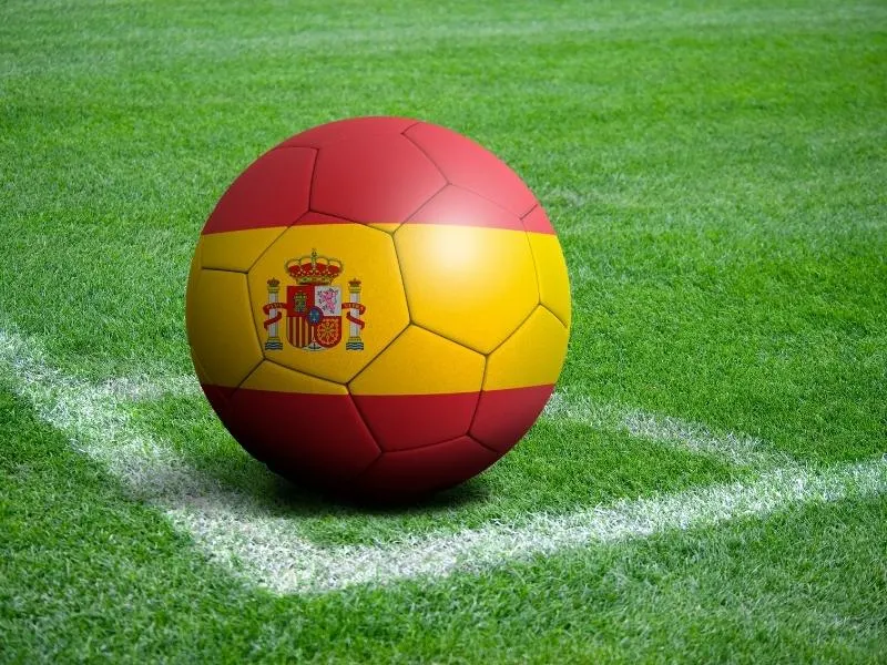 Football with Spanish flag on a pitch.