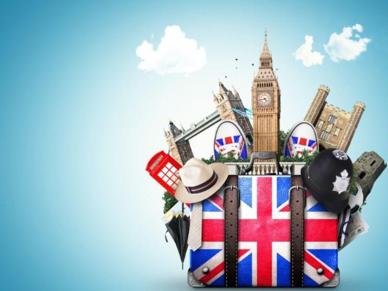 Union Jack suitcase with London landmarks sticking out of it.