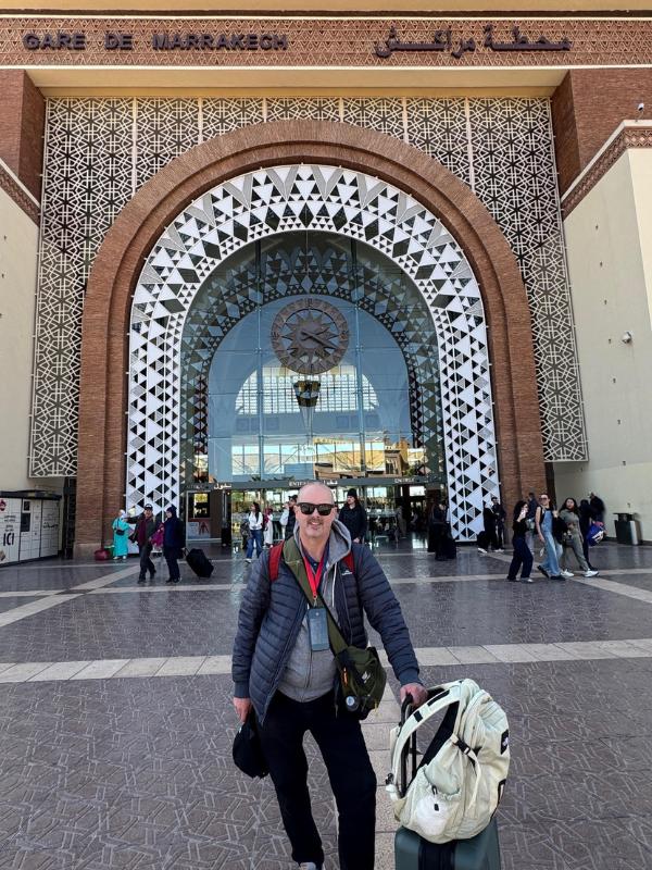 man in front of a train station.