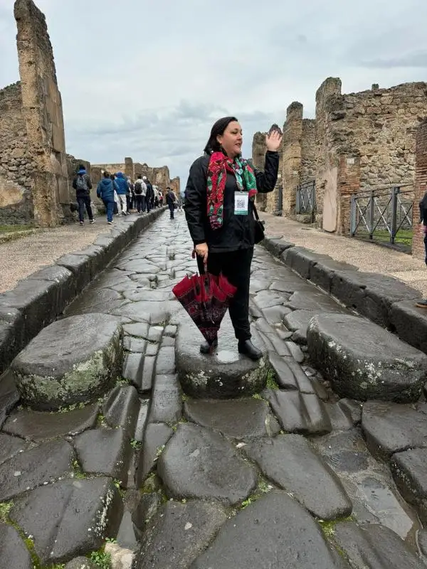 Woman standing on a Pompeii street.