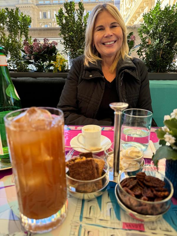 A lady with drinks on a table.