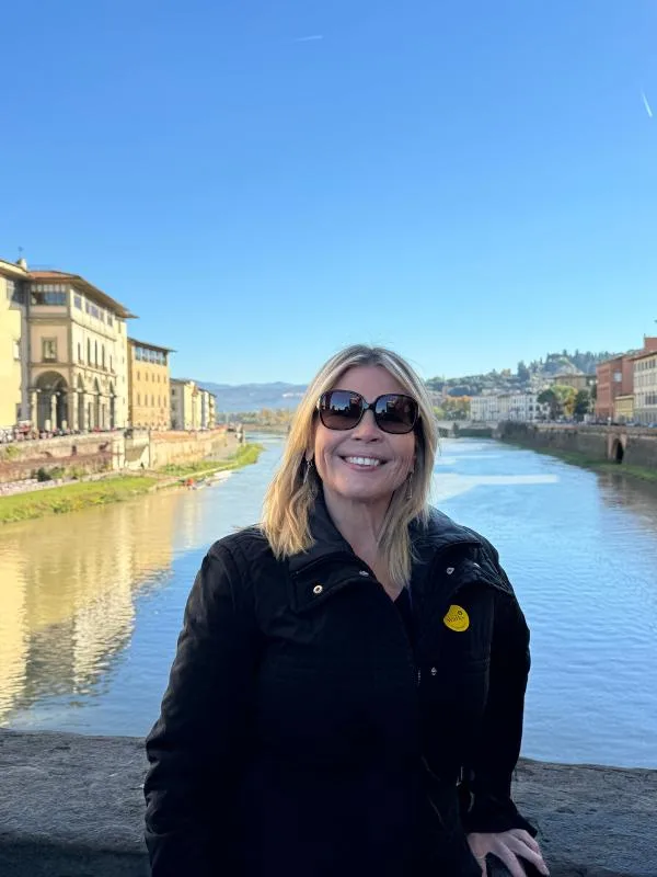 A lady with a river behind.