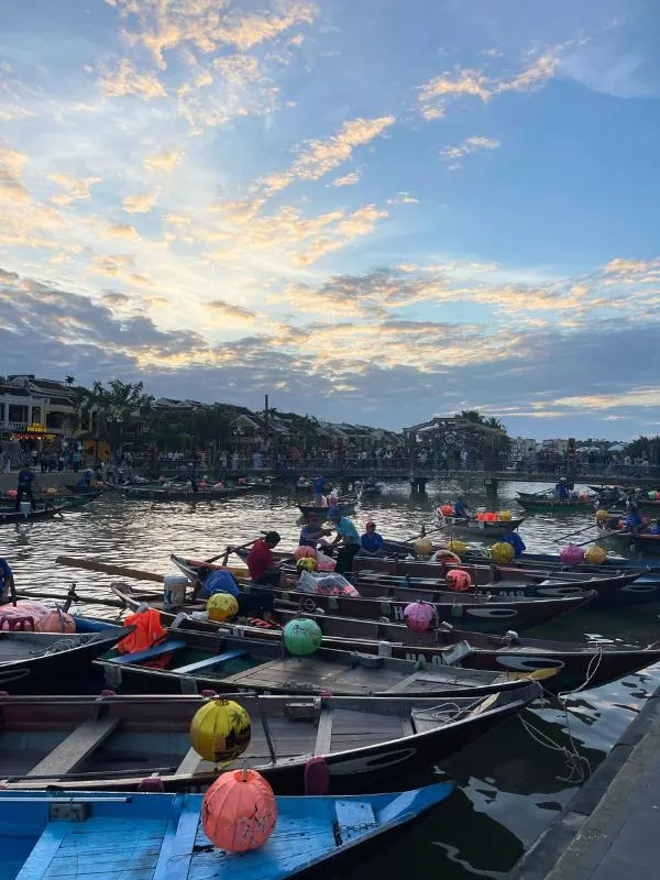 Boats on a river with colourful lanterns.