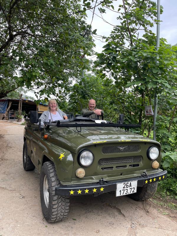Man and a woman in a jeep.